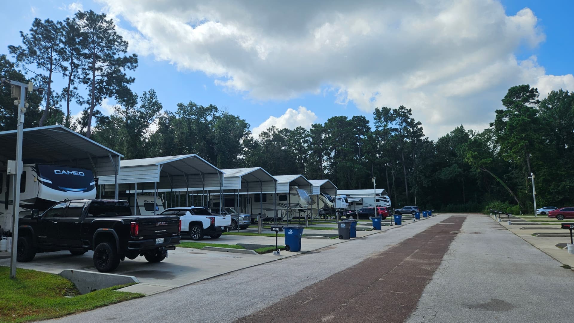 Covered RV spots with metal canopies along the park road