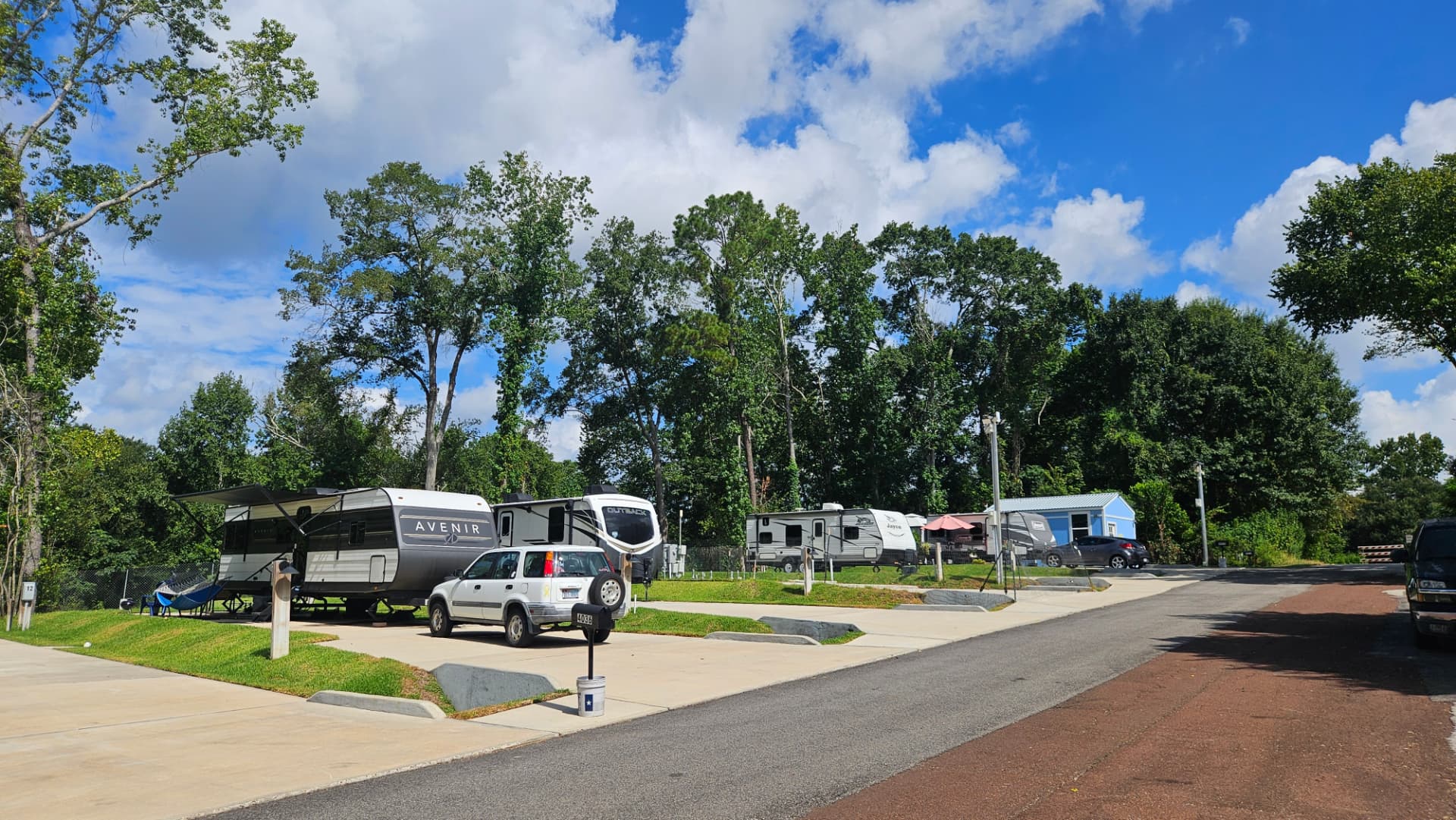 RV sites and concrete pads at The Woodland RV Park in Conroe, Texas