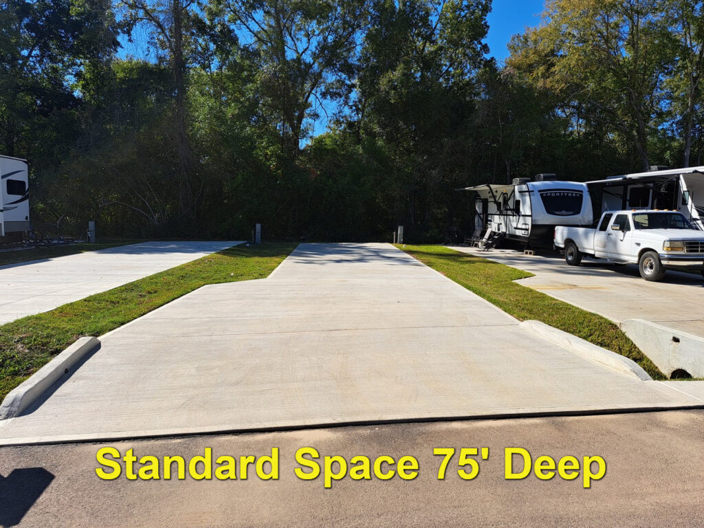 A level back-in RV site with full hookups at The Woodland RV Park