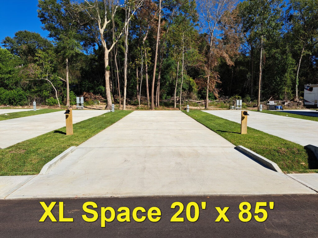 Extra-long concrete back-in pad at The Woodland RV Park